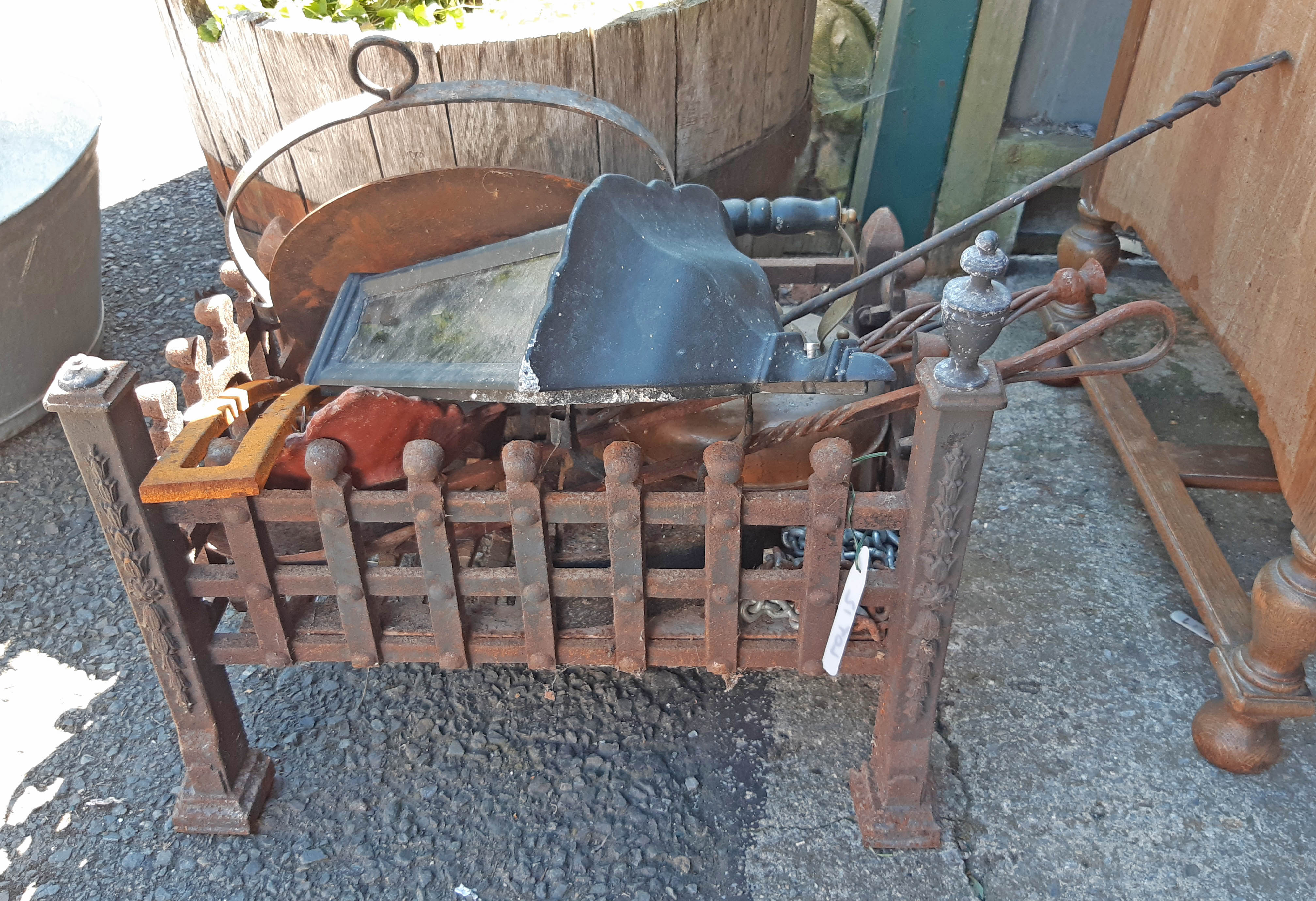 Assorted metalware including cast iron fire grate, skillet, kettle, outside lamp, etc.
