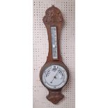 A carved oak cased banjo barometer/thermometer with printed ceramic dial and scale - repair