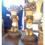 A pair of ornate candlesticks in the form of a putto with basket of fruit on head - stamped made