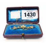 A marked 9ct. yellow metal ornate bar brooch, set with seed pearls - boxed
