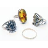 A white metal ring, set with amber cabochon containing a large fly - sold with three other white