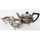 A three piece early 20th Century heavy gauge silver tea set with cast hoof pattern feet -
