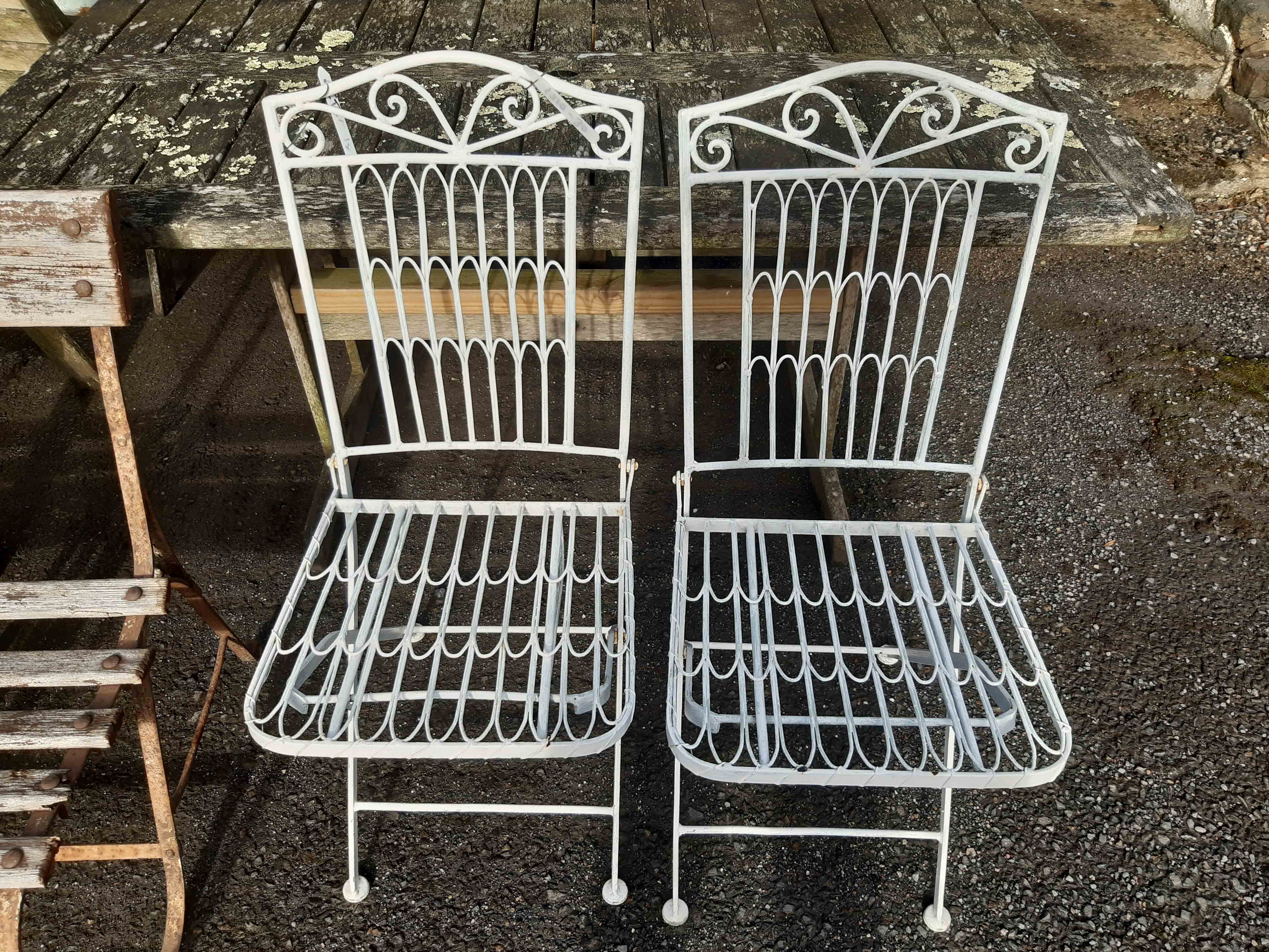 A pair of modern folding garden chairs