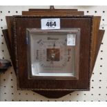 A mid 20th Century small oak cased wall barometer with visible aneroid works