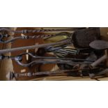 A box of assorted metalware, including fire irons, flat irons etc.