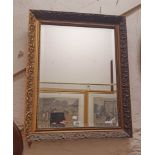 An ornate gilt framed bevelled oblong wall mirror