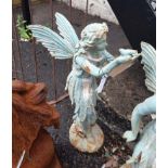 A cast iron standing fairy with bird