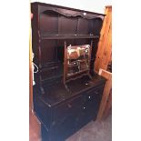 A 3' 8" Ercol dark stained elm two part dresser with two shelf open plate rack over a base with