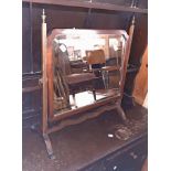 A 20th Century mahogany framed swing dressing table mirror in the antique style with shaped bevelled