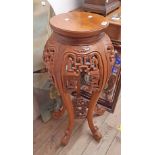 A modern Oriental stained hardwood jardiniere stand with pierced decoration, set on quadruple