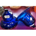 A pair of blue glass bell shaped shades