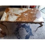 A retro brass framed and onyx topped coffee table