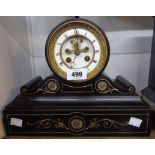 A late Victorian black slate cased drum and scroll mantel clock with Paris eight day bell striking