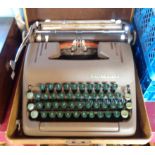 A vintage cased Smith Corona Silent typewriter with dark green keys