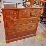 A 4' Edwardian polished walnut chest with central deep drawer, four flanking short drawers and three