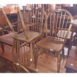 A set of four old hoop stick back kitchen chairs with moulded solid elm seats, bearing matching