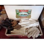 A vintage cigar box containing assorted items including gloves, etc.