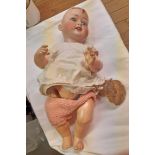 An early 20th Century Heubach Koppelsdorf German porcelain headed doll with composition body and