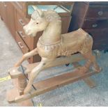 A large modern pine carved rocking horse on safety base