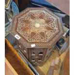 A 14 1/2" Indian hardwood Moorish style octagonal table with carved and inlaid decoration, set on