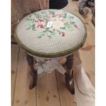 A late Victorian walnut stool with upholstered circular seat, set on ring turned supports -