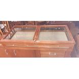 A 4' 2" teak framed table top display cabinet with locking and glazed bi-folding lift top and fall-