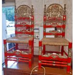 A pair of decorative painted wood and gilded ladder back armourial style standard chairs with