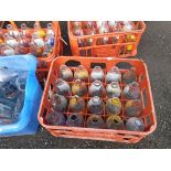 A vintage Unigate plastic milk crate containing twenty assorted advertising milk bottles