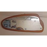 A retro teak bakcked wall mirror with shaped plate