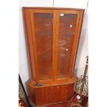 A 34" vintage teak corner cabinet with glazed doors to top, canted sides and cupboard doors to wider