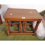 A nest of three polished oak tea tables, set on turned supports