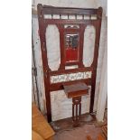 A 36" Edwardian stained walnut hallstand with spindle decoration remains of bevelled mirror plate,
