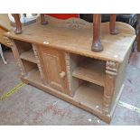A 3' 6" stripped pine low base with acorn decoration to back, central cupboard and flanking open