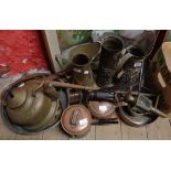 A selection of brass and copper including embossed jugs, saucepans, kettles, etc.