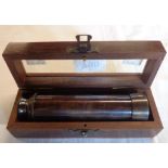 A modern brass telescope in wooden box