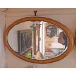A vintage gilt framed oval wall mirror with later finish