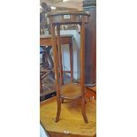 An Edwardian mahogany and strung two tier jardiniere stand, set on slender square swept supports