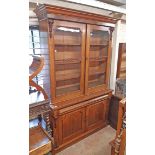 A 4' 8" Victorian mahogany two part book cabinet with moulded cornice and flanking capitals to
