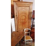 A 3' 1" Victorian waxed pine two part corner cupboard with shelves enclosed by two panelled doors (