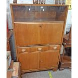 A 35 1/2" 1930/40's walnut German School cabinet with glass sliding doors, fall-front compartment,