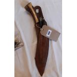 A mid 20th Century kukri with remains of scabbard and side knives