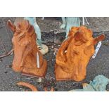 A pair of cast iron horse heads - 1 with chip to base