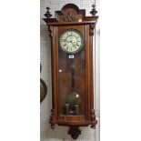 A late 19th Century polished walnut cased Vienna style regulator wall clock with visible pendulum