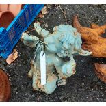 A small painted cast iron cherub with trumpet