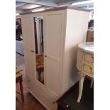A 3' 11 1/2" modern Ludlow triple wardrobe with hanging space enclosed by central mirror panel