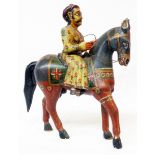 An antique Indian carved wood and painted figurine of a man on a horse