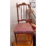 A late Victorian stained wood framed spindle back bedroom chair with remains of upholstery