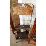 A 3' 2" high vintage painted metal commercial display stand with two graduated shelves remains of