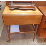 A vintage polished oak drop-leaf two tier tea trolley with flanking drawers