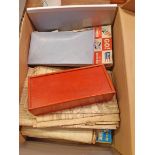 A box contaning a quantity of assorted collectable items including shell beads, matchboxes, maps,